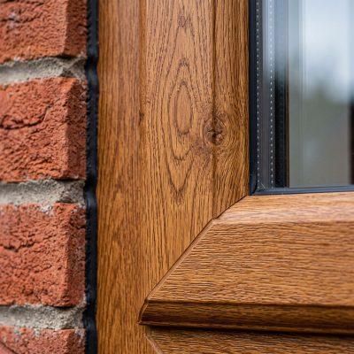 Woodgrain effect uPVC window with authentic oak timber texture and long-lasting colour finish.
